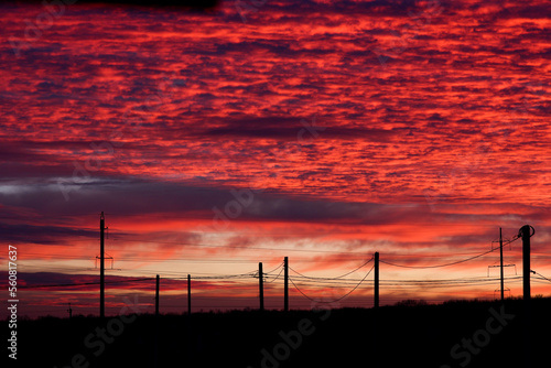 the sky red sunset clouds the evening poles electric wires