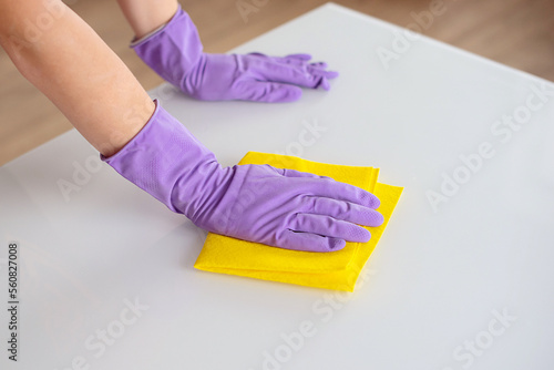 woman doing chores at home with spray detergent suds sponge. Cropped view