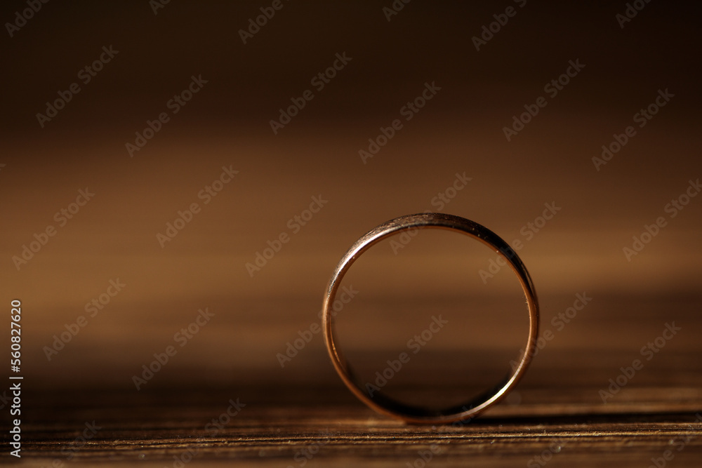 golden ring close-up, macro, on a wood background golden ring close-up, macro, on a wood background