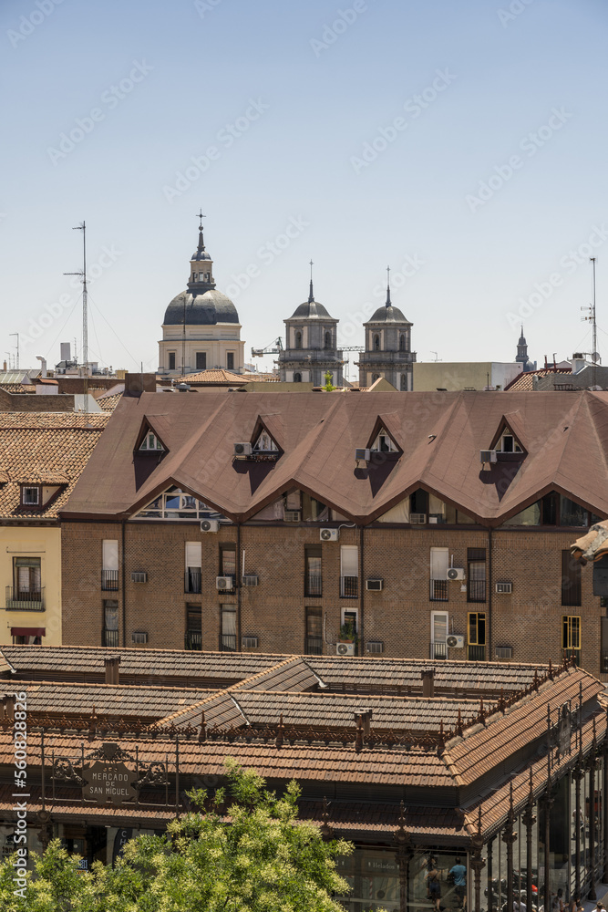 roofs and facades of the San Miguel market and surrounding buildings in the center of the city of Madrid
