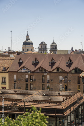 roofs and facades of the San Miguel market and surrounding buildings in the center of the city of Madrid
