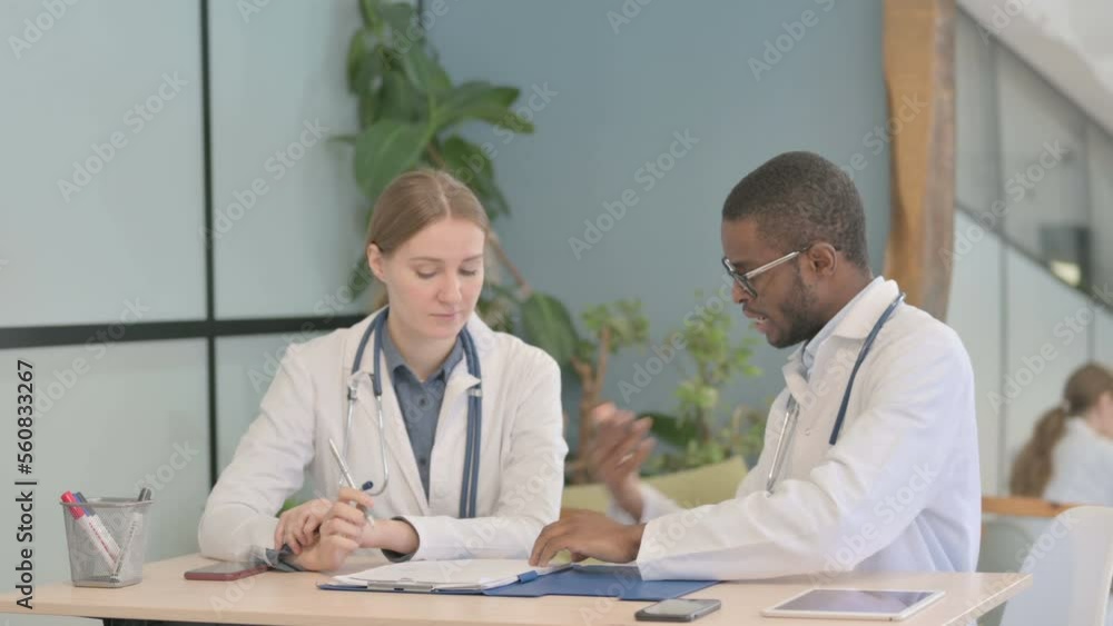 African Doctor and Female Doctor Working in Clinic African Doctor and Female Doctor Working in Clinic