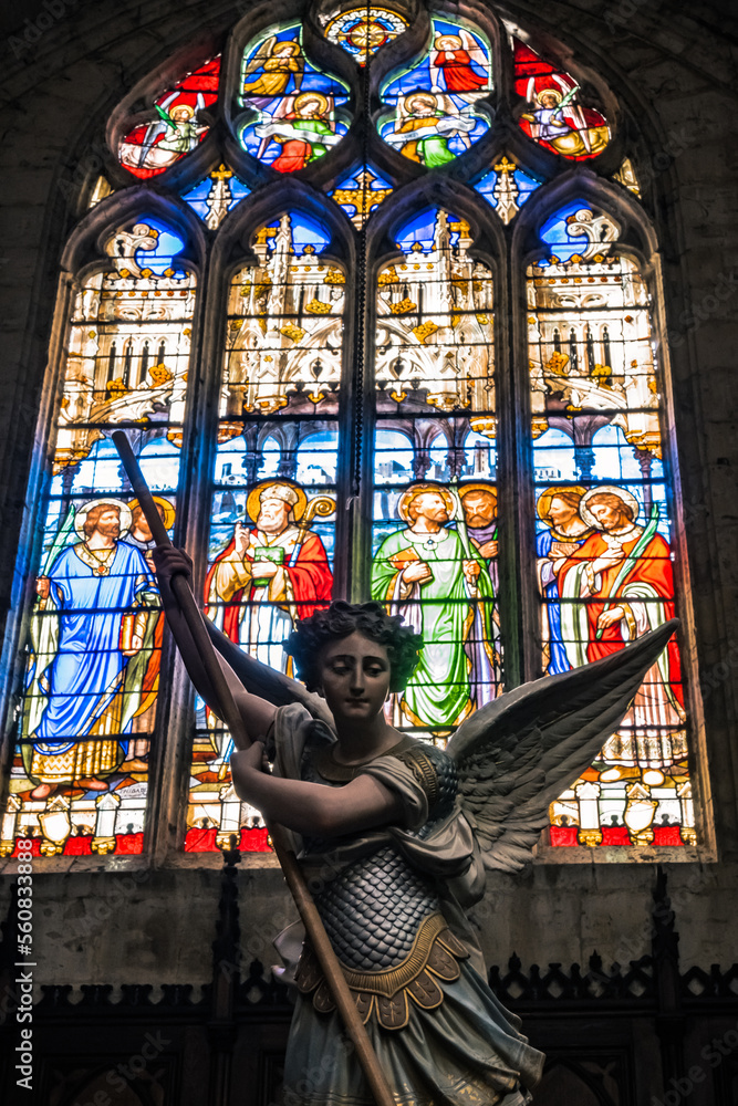 Angel and stained glass window inside the Saint-Gervais Saint-Protais Cathedral of the small town of Lectoure in the south of France (Gers)
