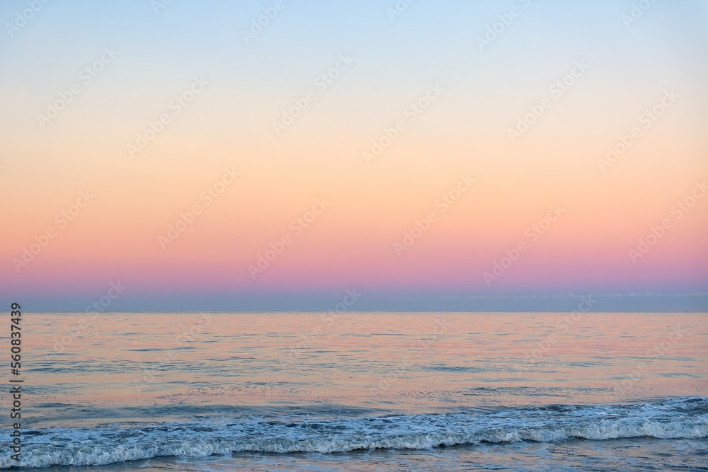 Beautiful sunny and pink sunrise on the beach