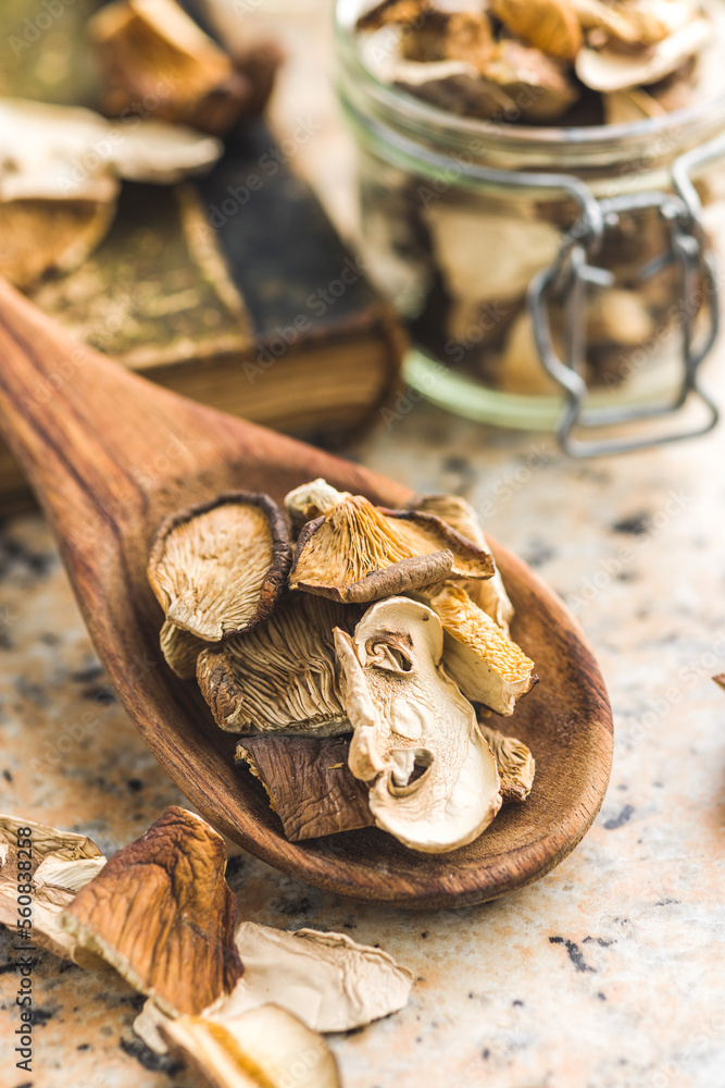 Sliced dried mushrooms in wooden spoon. Sliced dried mushrooms in wooden spoon.