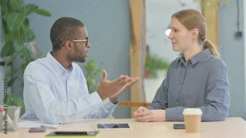 Young African Businessman Discussing Work with Partner Young African Businessman Discussing Work with Partner