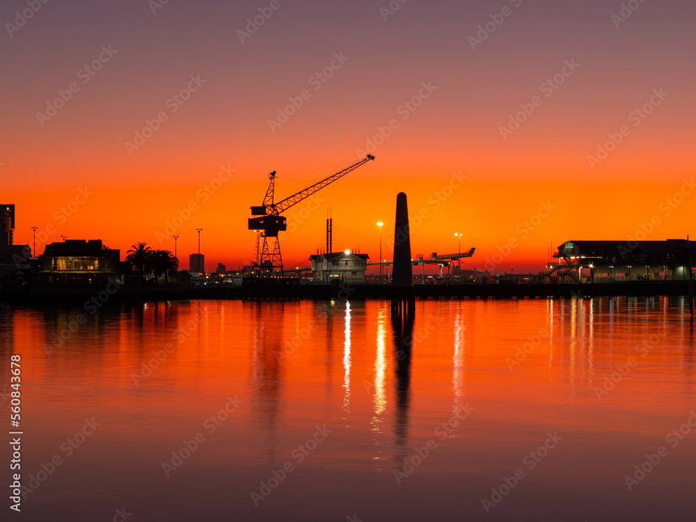 Silhouette of crane at Port Melbourne during sunrise time.