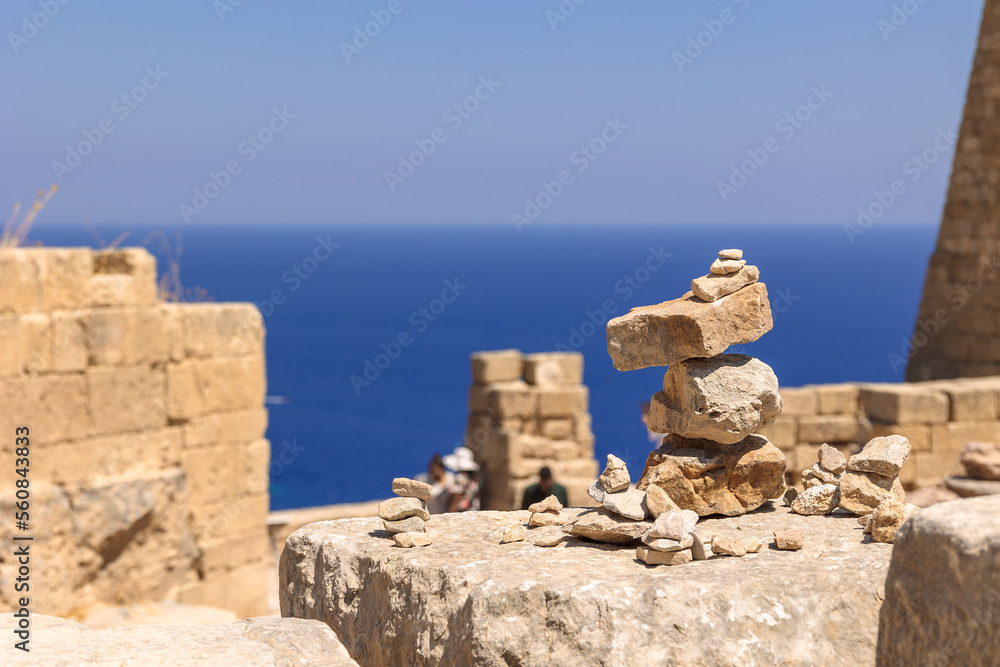 Panoramic view of ruins of ancient city of Lindos on colorful island of Rhodes, Greece. Famous tourist attraction. Ancient temple Greek architecture. High quality photo