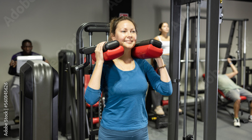 Caucasian woman training on calf raise machine in gym © JackF