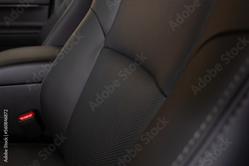 Luxury car inside. Interior of a prestigious modern car. Comfortable leather seats. Cockpit in black perforated leather. © Brylynskyi