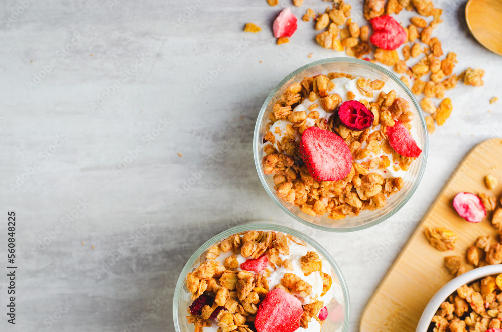 Granola and Yogurt Parfaits, Healthy Breakfast or Snack, Muesli with Dried Berries on Bright Concrete Background Granola and Yogurt Parfaits, Healthy Breakfast or Snack, Muesli with Dried Berries on Bright Concrete Background
