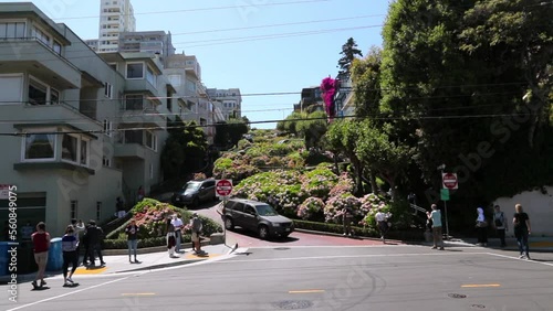 Slow Motion Shot Of Cars Moving On Zigzag Road Amidst Trees And Buildings During Sunny Day - San Francisco, California
