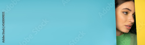 Teen girl standing near colorful background with copy space, banner. © LIGHTFIELD STUDIOS