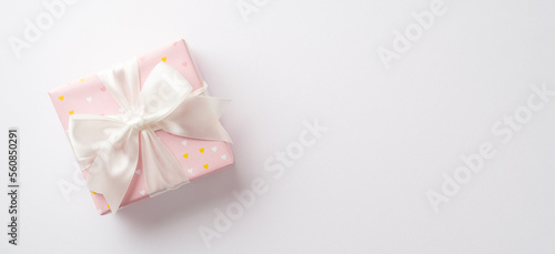 Saint Valentine's Day concept. Top view photo of pastel pink present box with silk ribbon bow on isolated white background with copyspace © ActionGP