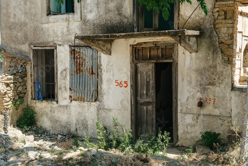 Old abandoned building with open door and windows