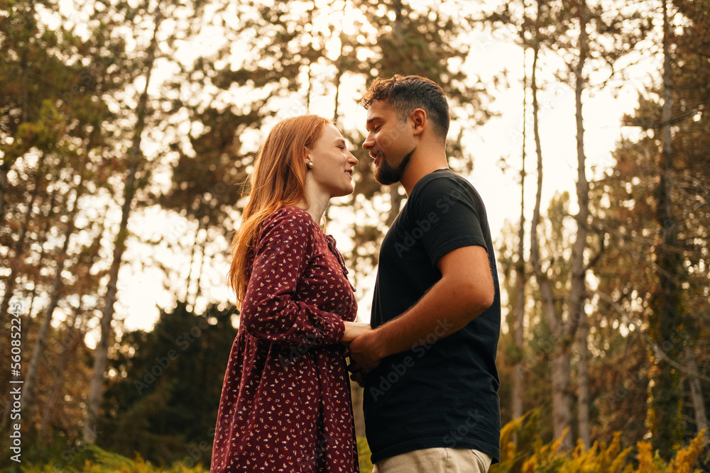 Cheerful young couple are smiling and looking at each other in the eyes. Cheerful young couple are smiling and looking at each other in the eyes.