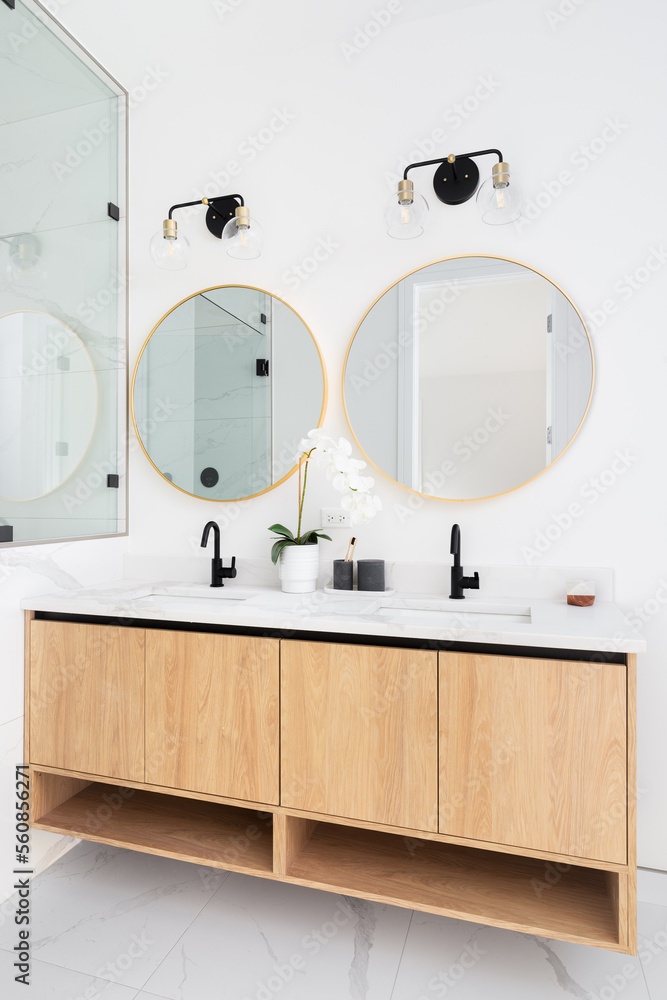 A beautiful bathroom with a floating wood cabinet marble