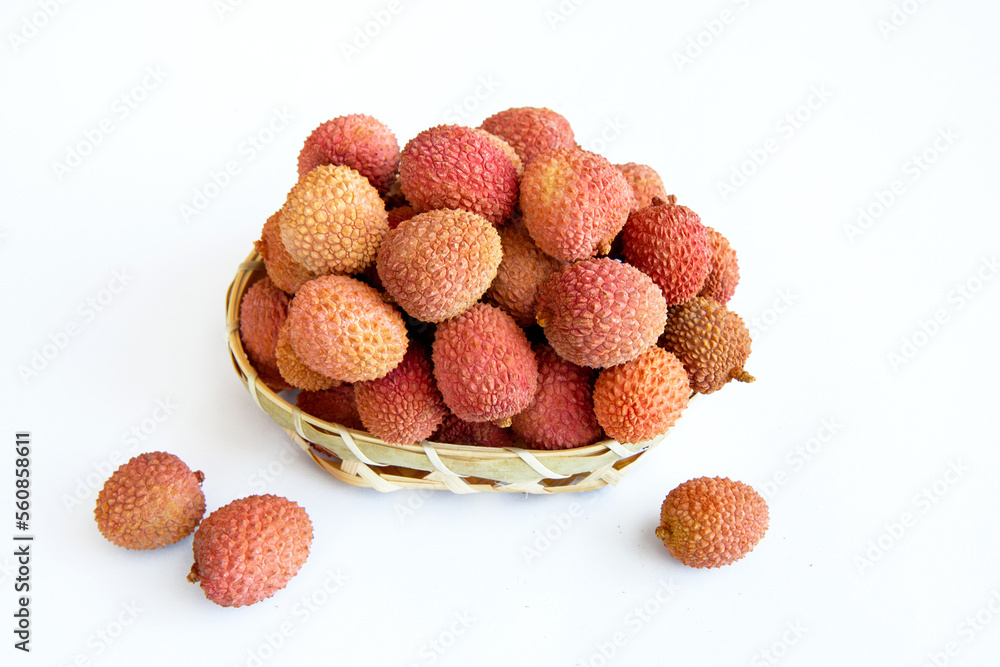 Lychee fruits in a basket on a white background 