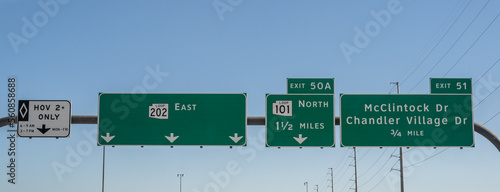 signs on the Santan Freeway, 202 Loop East in Chandler, Arizona for HOV lane, Exit 50A 101 Loop North, and Exit 51 McClintock Dr and Chandler Village Drive