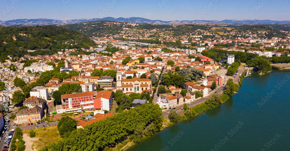 Scenic aerial view of French commune of Givors on banks of Rhone river on summer day, Metropolitan Lyon