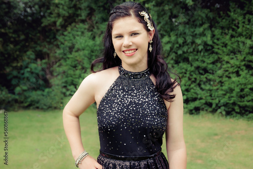 Close up of smiling teenage girl in black sequin racerback prom dress photo