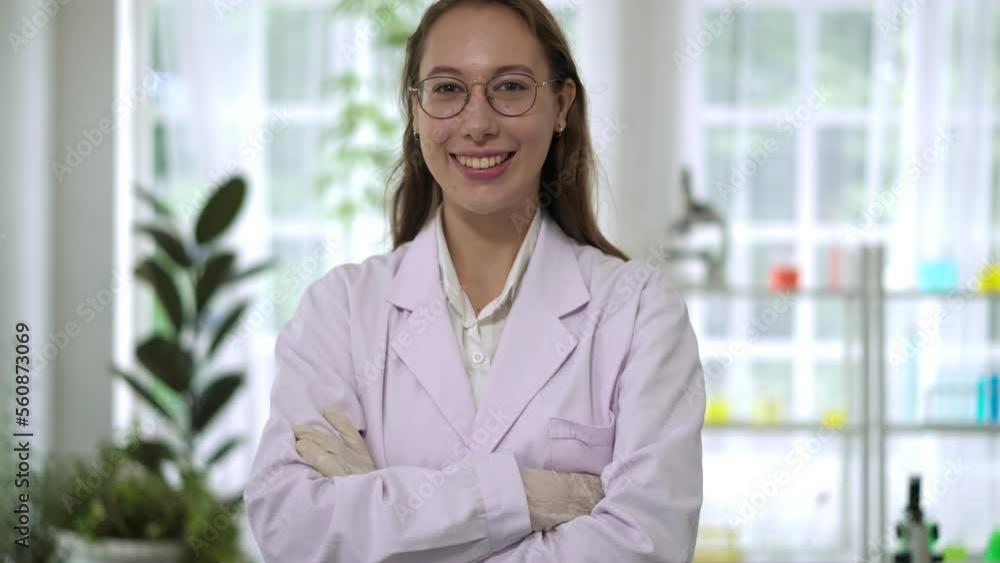 Portrait young scientist female standing with cross arms in laboratory Portrait young scientist female standing with cross arms in laboratory