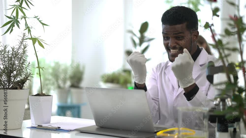 Young Scientist man typing on laptop computer and glad in successful Young Scientist man typing on laptop computer and glad in successful