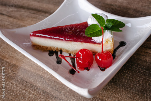 Cheesecake de zarzamora con cereza, menta y crema batida  photo