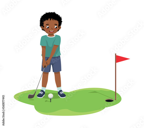 Cute little African boy playing golf ready to hit ball aiming at the hole