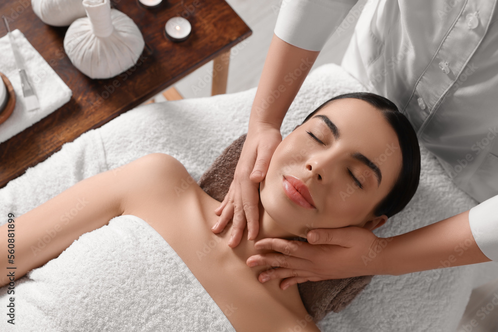 Young woman enjoying professional massage in spa salon, above view - obrazy, fototapety, plakaty 