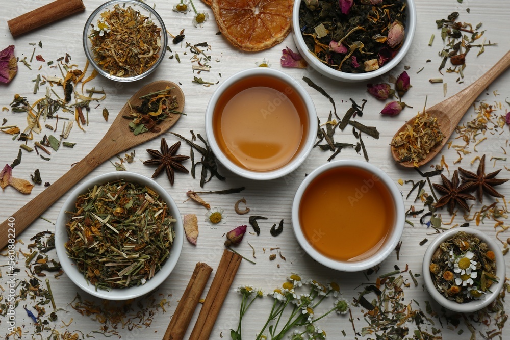 Flat lay composition with fresh brewed tea and dry leaves on wooden table Flat lay composition with fresh brewed tea and dry leaves on wooden table