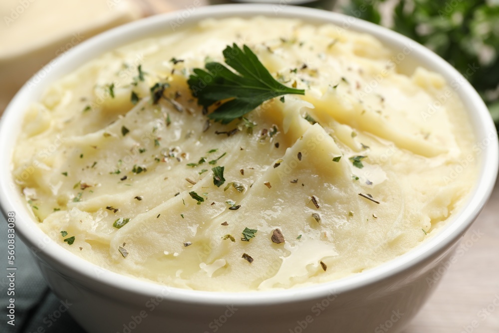 Bowl of delicious mashed potato with parsley, closeup