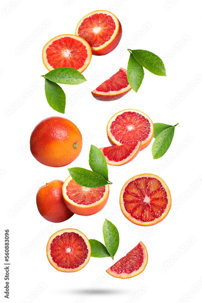 Naklejka premium Red oranges with green leaves falling on white background