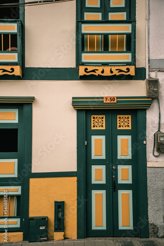 Wallpaper Mural a green ands yellow old building with windows and door Torontodigital.ca