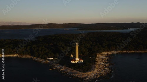 Drone footage. The sea and a beautiful view of the lighthouse on the island. photo