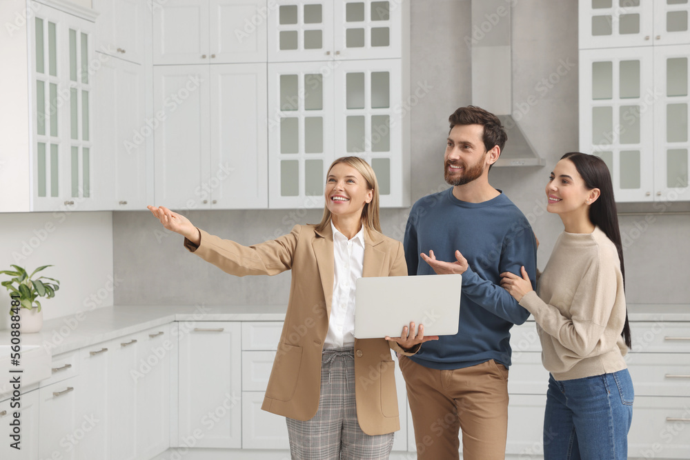 Real estate agent showing new apartment to couple Real estate agent showing new apartment to couple