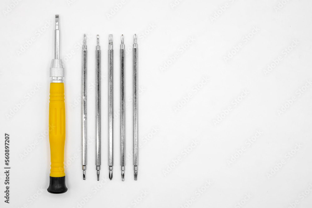 universal screwdriver with a set of interchangeable bits on a white background universal screwdriver with a set of interchangeable bits on a white background