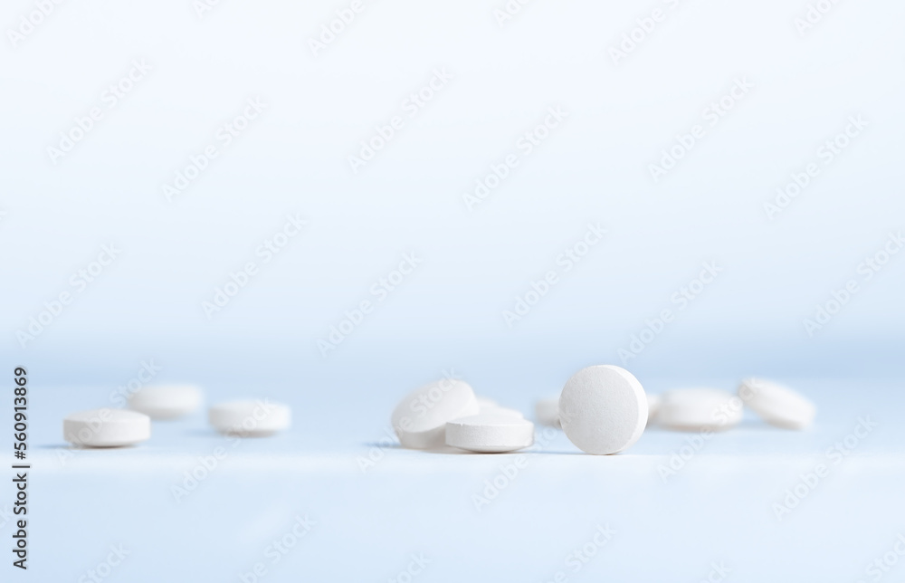 Pharmacy theme, white pills scattered on the table.