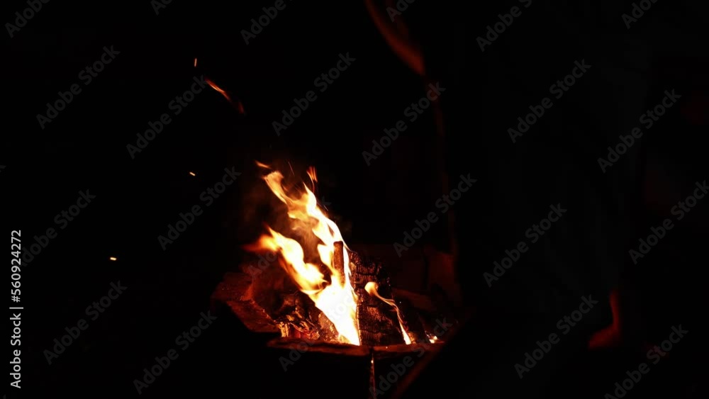Man Putting The Logs On The Fire - close up Man Putting The Logs On The Fire - close up