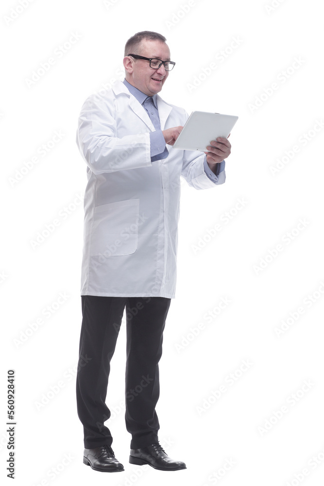 in full growth. a competent mature doctor with a digital tablet. in full growth. a competent mature doctor with a digital tablet.