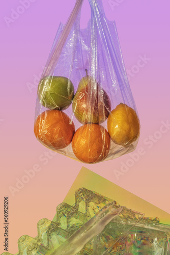 Still life with fruits and plastic trash. The topic of microplastics in food. With the effect of photoelasticity. Pastel rainbow colors, front view