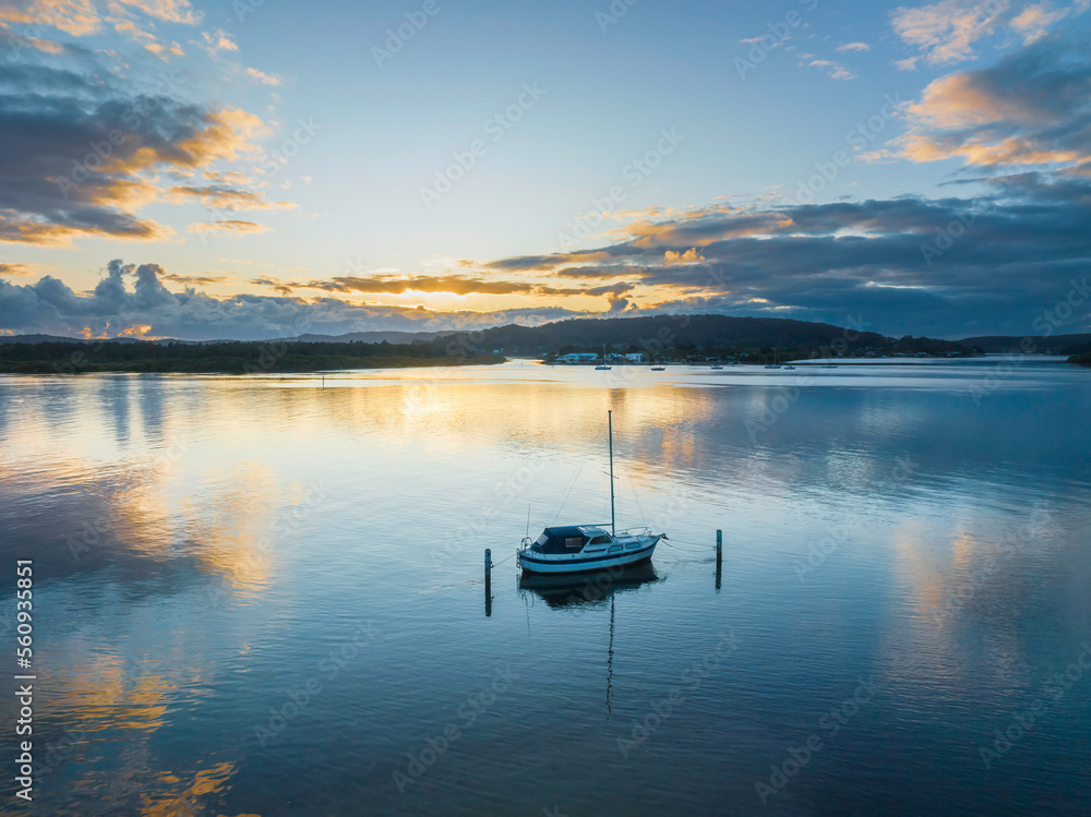 Sunrise over the bay with clouds and reflections