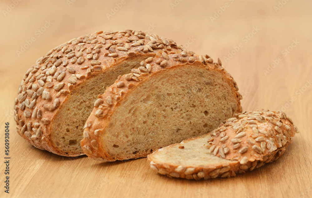 Wheat bread whole coated with sunflower seeds isolated on white Wheat bread whole coated with sunflower seeds isolated on white