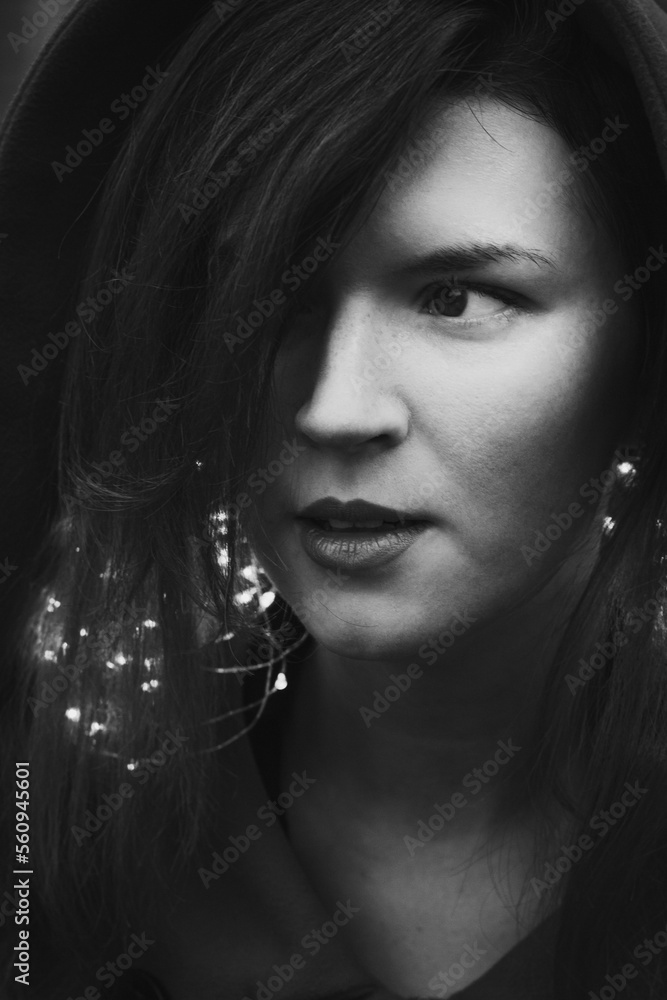 Close up woman with glowing fairy lights monochrome portrait picture. Closeup front view photography with blurry background. High quality photo for ads, travel blog, magazine, article Close up woman with glowing fairy lights monochrome portrait picture. Closeup front view photography with blurry background. High quality photo for ads, travel blog, magazine, article