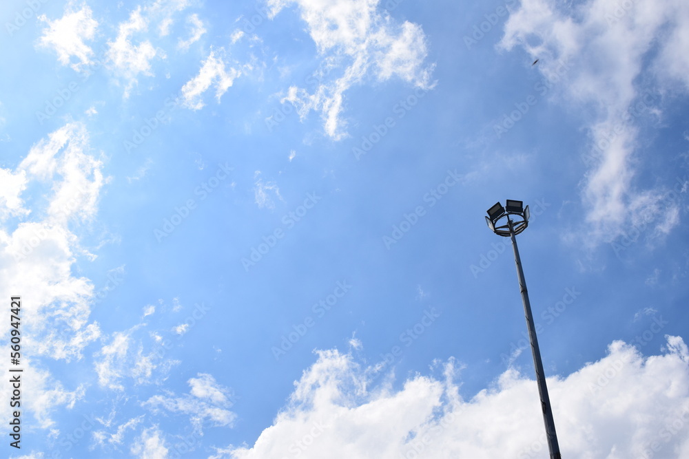 Electric Lampposts on blue sky in sunny weather. Lamp for home garden lighting.