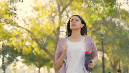 Woman running with water bottle photo