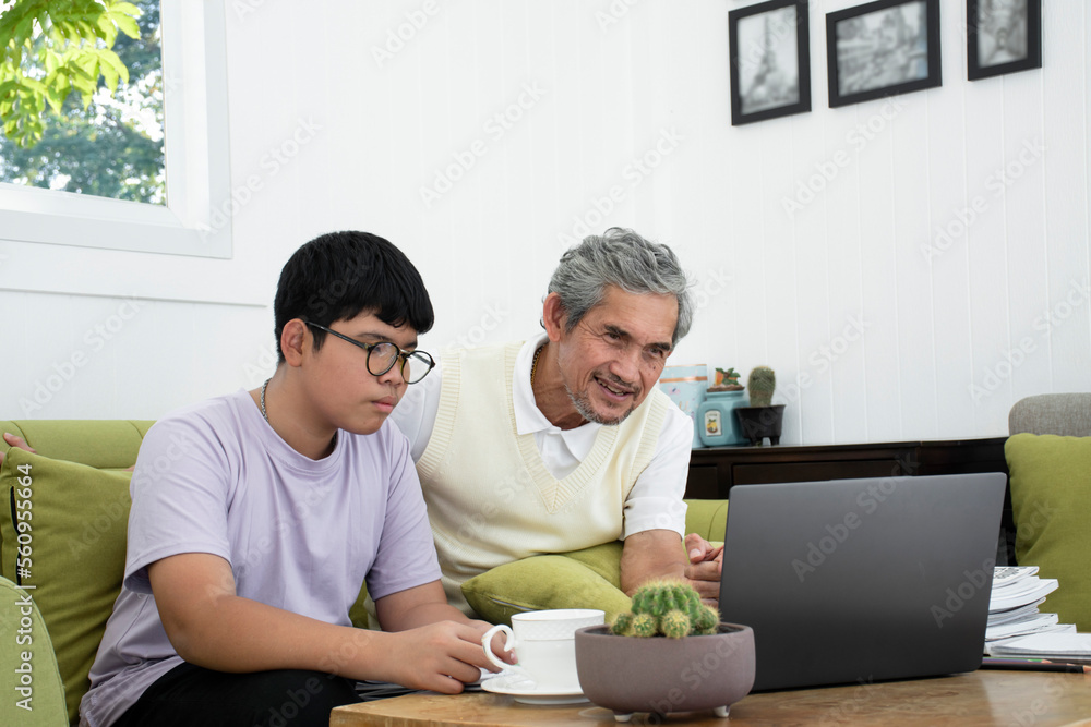 Grandfather is spending his free time with his grandson in the living room by talking, listening to music, discussing his past life experiences and adapting to modern society, raising teens concept. Grandfather is spending his free time with his grandson in the living room by talking, listening to music, discussing his past life experiences and adapting to modern society, raising teens concept.