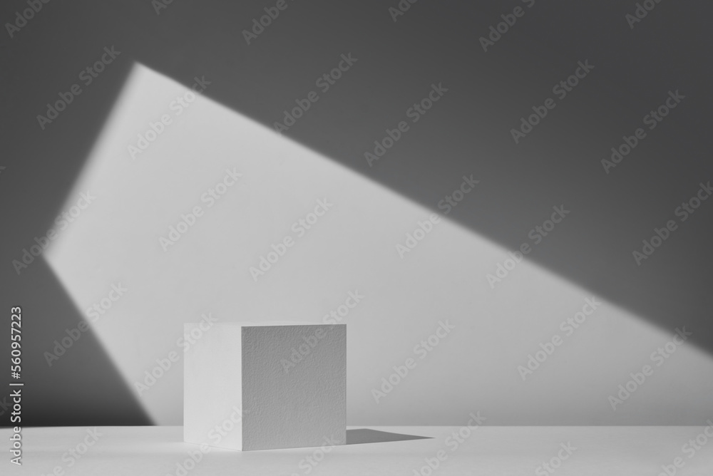 White square podium with shadow on the wall White square podium with shadow on the wall