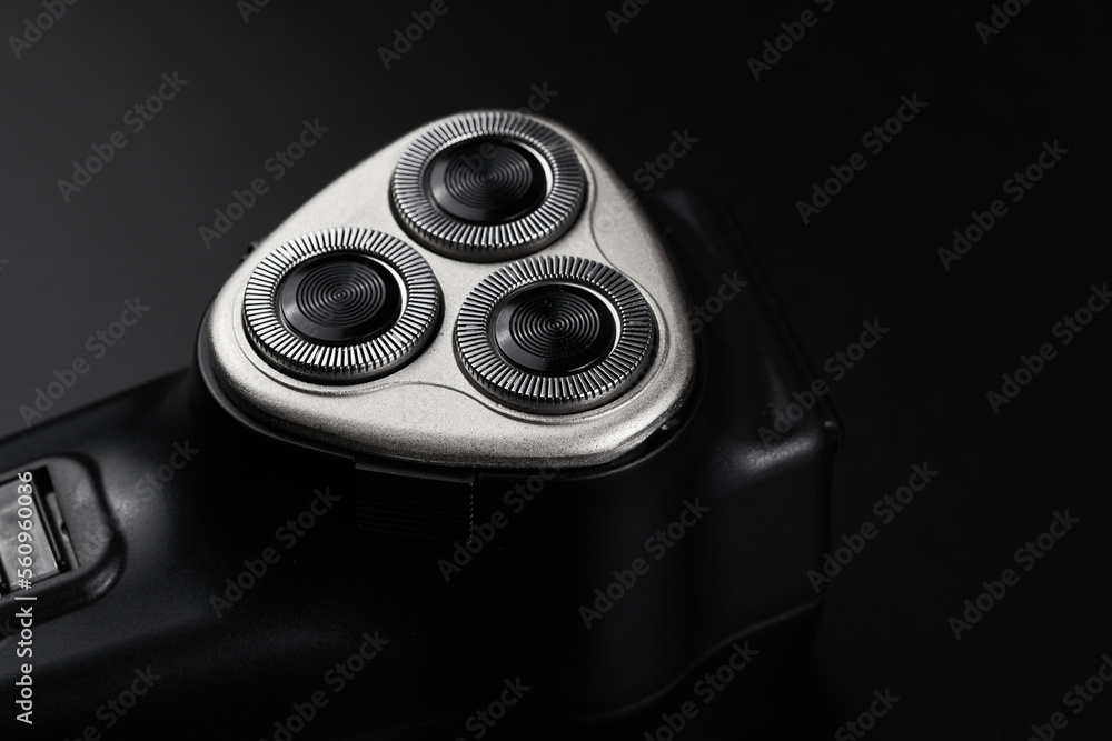 Black male electric razor closeup isolated on black background Black male electric razor closeup isolated on black background