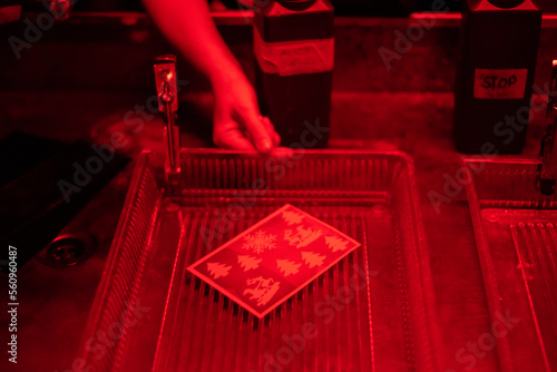 Photography Developing a photo in a photo darkroom under red light